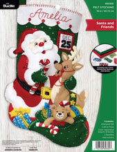 Load image into Gallery viewer, Bucilla felt christmas stocking kit. Design features santa with his bag of toys  and a reindeer. Calendar with Dec 25 in the background.