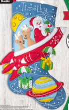 Load image into Gallery viewer, Bucilla felt christmas stocking kit. Design features Santa  and 2 deer in a red rocket ship while dropping gifts.