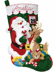 Bucilla felt christmas stocking kit. Design features santa with his bag of toys  and a reindeer. Calendar with Dec 25 in the background.