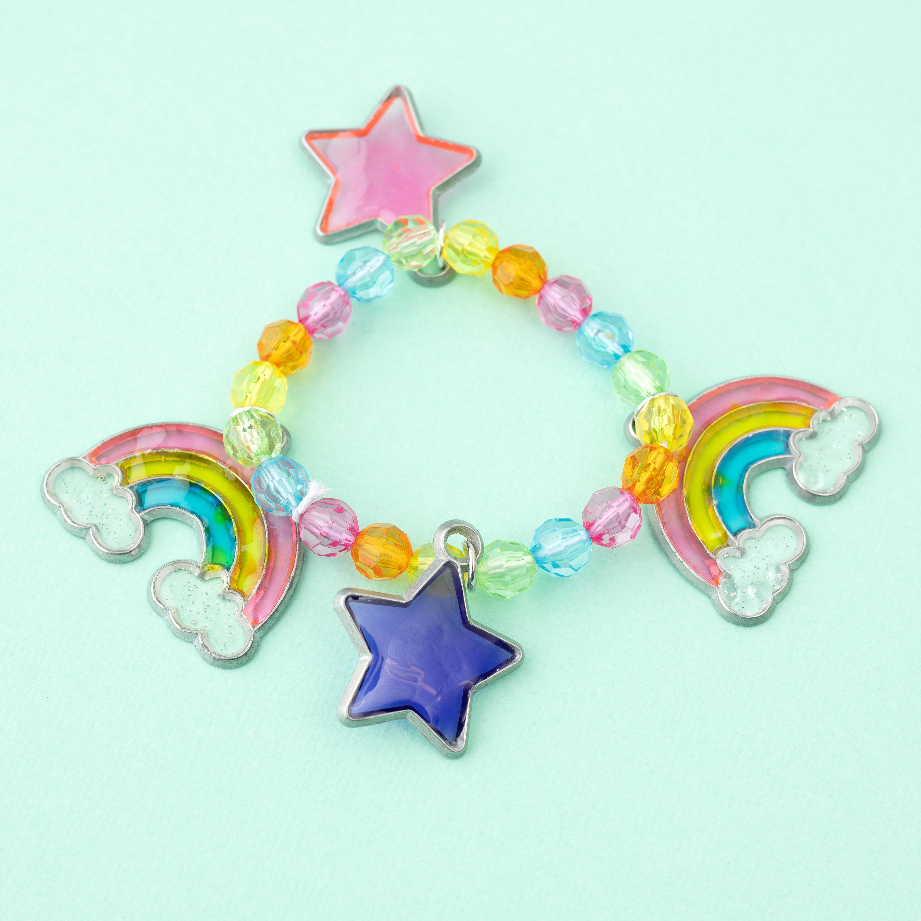 A beaded bracelet with stars and rainbow sun catcher charms.