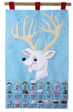 Load image into Gallery viewer, Bucilla felt wall hanging kit. Design features a reindeer with large antlers that hold the twenty-four ornaments. Below the deer, there are twenty-four pockets.