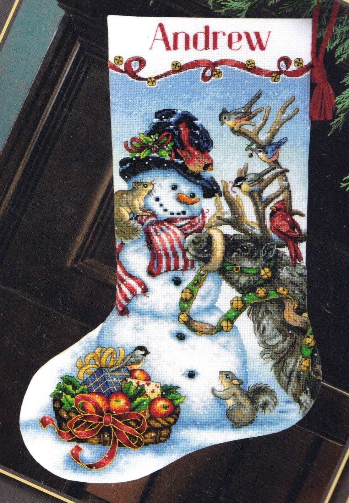 Counted cross stitch christmas stocking kit. Design features a  snowman with all of his woodland friends. animals and fruit gift basket in the background.