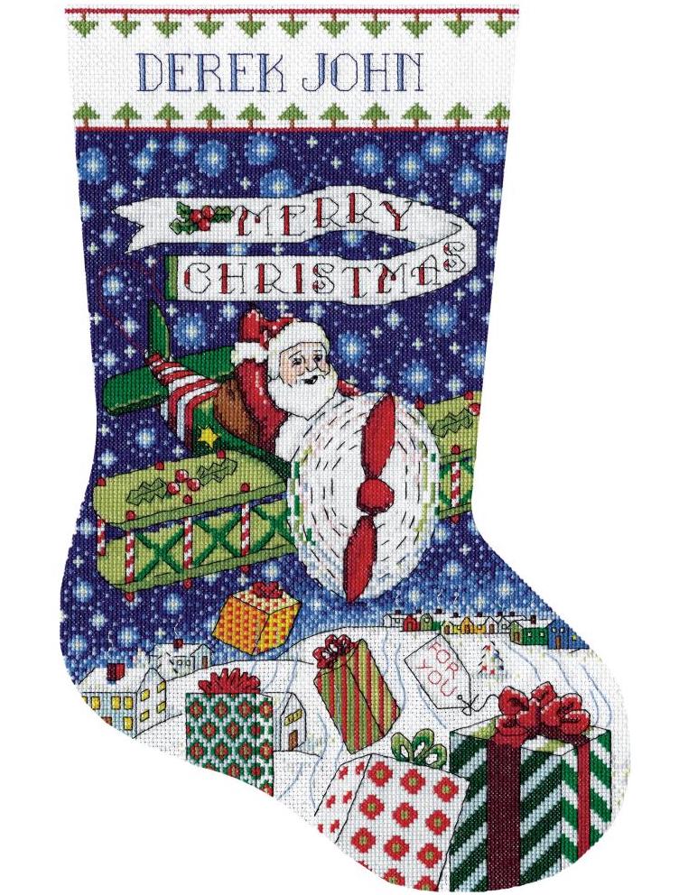 Counted cross stitch christmas stocking kit. Design features santa flying in a small propeller plane while dropping gifts to the town below.