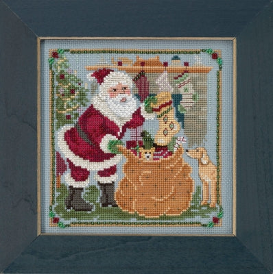 Mill Hill counted cross stitch kit. Design features Santa filling stockings.