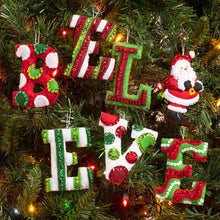 Load image into Gallery viewer, Bucilla Felt Christmas ornament kit. Design features felt letters that spell believe with the I being a santa.