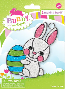 Makit and Bakit Kit. Design features a white bunny with pink ears and cheeks holding a blue and green easter egg. 