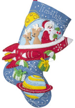 Load image into Gallery viewer, Bucilla felt christmas stocking kit. Design features Santa and 2 deer in a red rocket ship while dropping gifts.
