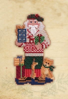 Mill Hill counted cross stitch kit. Design features Santa wearing a sweater and holding gifts. An orange cat stands to the side.