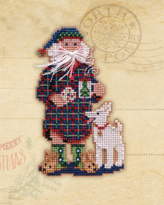 Mill Hill counted cross stitch kit. Design features Santa in his pajamas with a cookie  and  a white dog. 