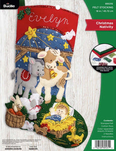 Bucilla felt christmas stocking kit. Design features the baby Jesus surrounded by baby animals in a manger.