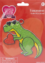 Load image into Gallery viewer, Colorbok Suncatcher kit. Design features a green dinosaur with a red heart. 