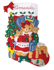 Bucilla felt christmas stocking kit. Design features a Mama bear reading a story to her two baby cubs. the background is a living room setting.