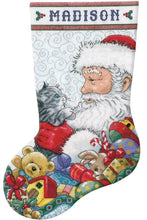 Load image into Gallery viewer, Counted Cross stitch christmas stocking kit. the design is santa holding a gray and white kitten. Toys intthe background. 