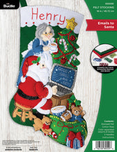 Load image into Gallery viewer, Bucilla felt stocking kit. Design features Santa on his computer with Mrs Claus watching over his shoulder.