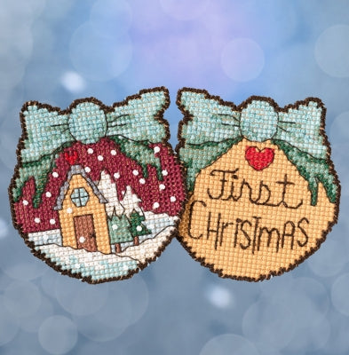 Mill Hill Sticks counted cross stitch ornament kit. Design features a double sided ornament with first christmas on one side and a snowy house scene on the other.