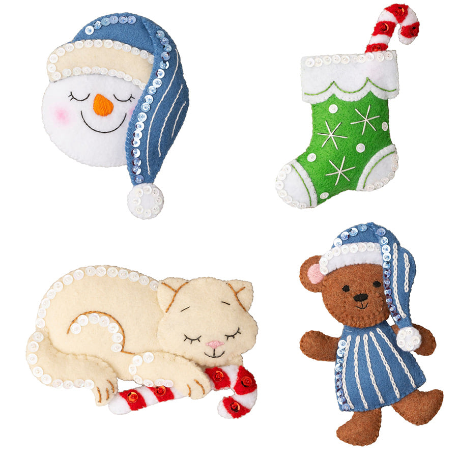 Bucilla felt ornament kit. Design features four ornaments.  A cat with candy cane. S sleeping snowman. a stocking with candy cane. and a teddy bear in pajamas.