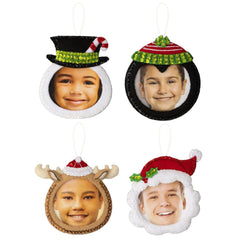 Bucilla Felt Christmas ornament kit. Design features four photo ornament. The photos can be put in the face of a snowman, deer, santa, and penguin.