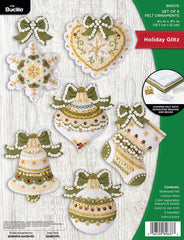 Bucilla felt Christmas ornament kit. Design features ornaments, stockings, snowflake, bell, heart. Colors used are green, white and cream.