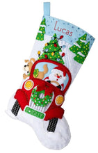 Load image into Gallery viewer, Bucilla felt stocking kit. Design features Santa and Puppy making Christmas tree deliveries in  an old red truck.