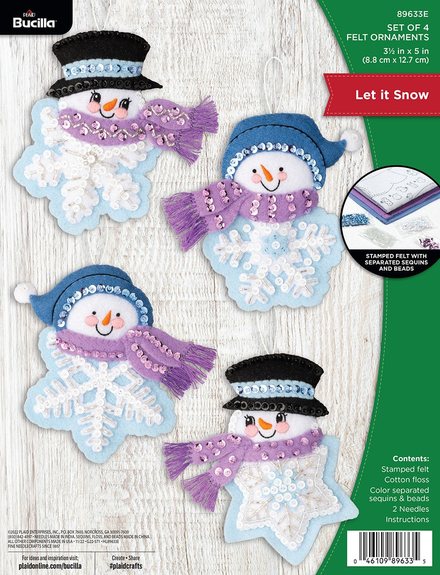 Bucilla Felt Christmas ornament kit. Design features snowman heads on top of blue and white snowflakes.