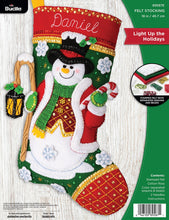 Load image into Gallery viewer, Bucilla felt Christmas stocking kit, Design features a snowman with lantern and candy cane.