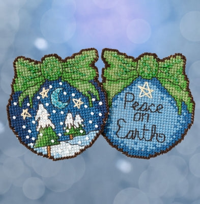 Mill Hill Sticks counted cross stitch ornament kit. Design features a double sided ornament with peace on earth on one side and snow covered trees on the other. 