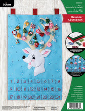 Load image into Gallery viewer, Bucilla felt wall hanging kit. Design features a reindeer with large antlers that hold the twenty-four  ornaments.  Below the deer, there are twenty-four pockets.