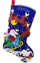 Bucilla Felt christmas stocking kit. Design features santa in his sleigh with reindeer  flying over the rooftops. 