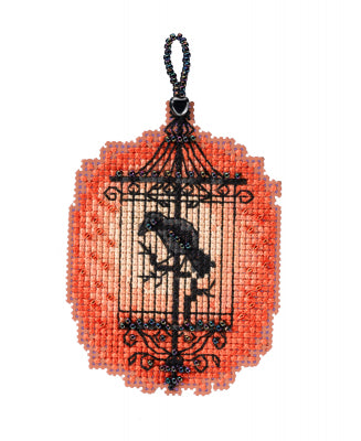 Mill Hill counted cross stitch ornament kit. Design features a black bird in a birdcage with orange background.