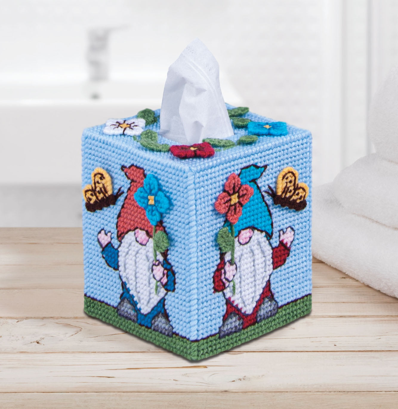 Plastic Canvas Tissue Box Cover Kit. This Design features colorful gnomes with butterflies and flowers.