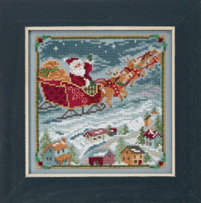 Mill Hill counted cross stitch kit. Design features Santa in his sleigh flying over the rooftops.