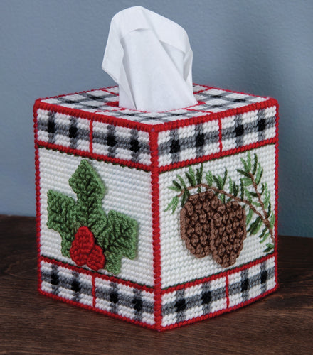 Plastic Canvas Tissue Box Cover Kit. This Design features a red, black and white plaid with winter leaves and pinecones.