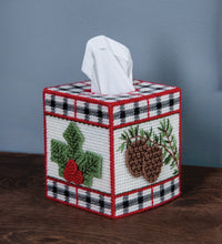 Load image into Gallery viewer, Plastic Canvas Tissue Box Cover Kit. This Design features a red, black and white plaid with winter leaves and pinecones. 